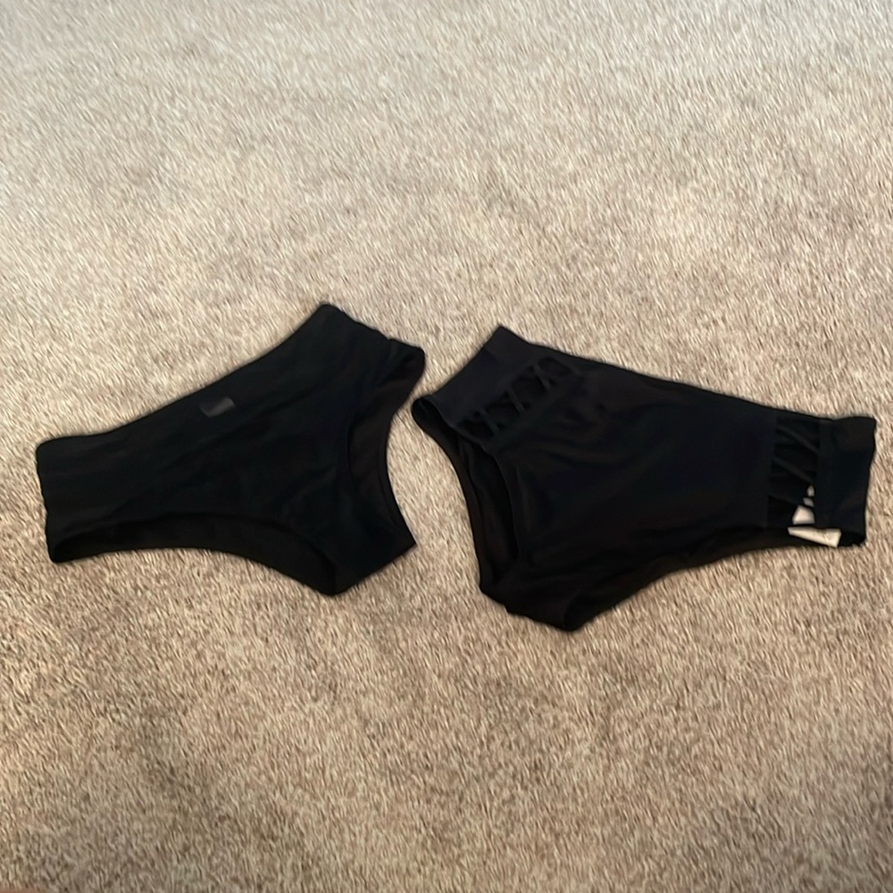 Two black high waisted bikini bottoms.